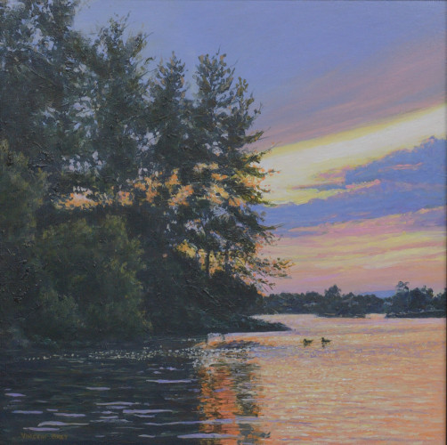 Lake scene featuring a colorful cloud-filled sky